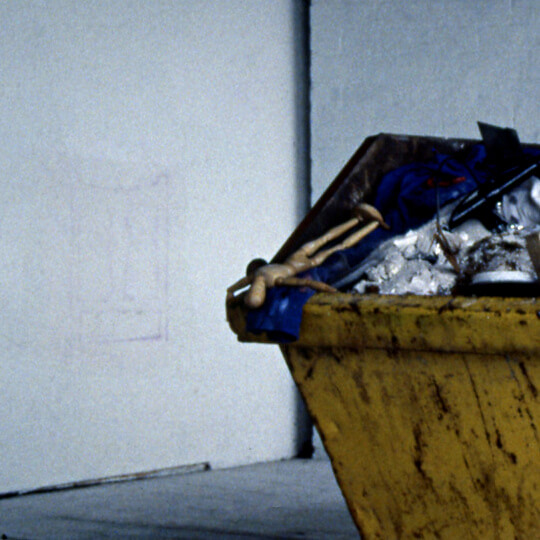 Skip filled with disused art equipment