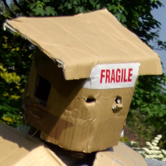 Student covered in packaging and fragile tape